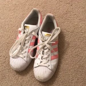 Pink and white adidas superstars